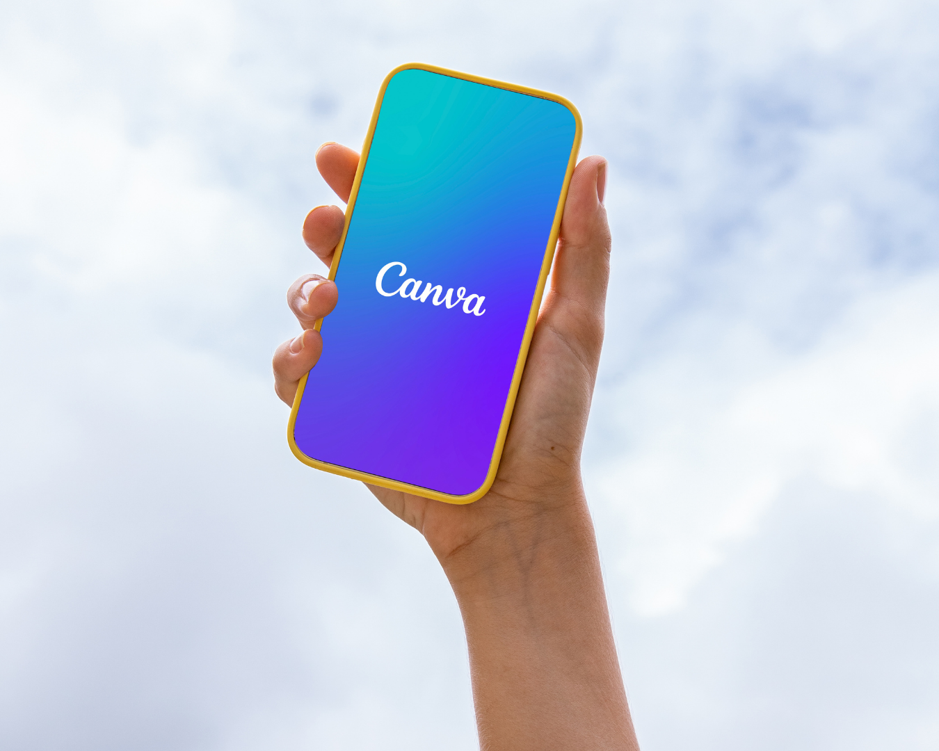 Mastering the Future of Content Creation with Canva AI - Image of hand holding cell phone with the Canva logo on phone screen